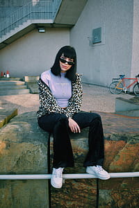 Woman Sitting on Ledge thumbnail
