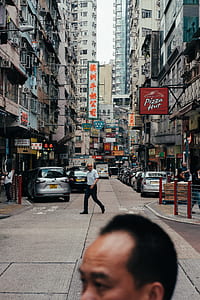 man in white shirt standing near gray car thumbnail