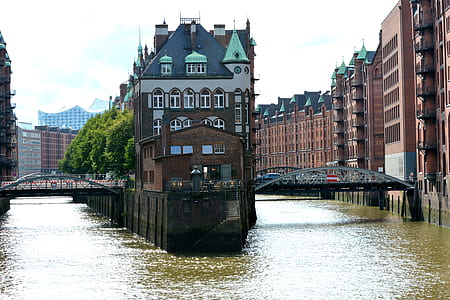 brown building surrounded with water thumbnail