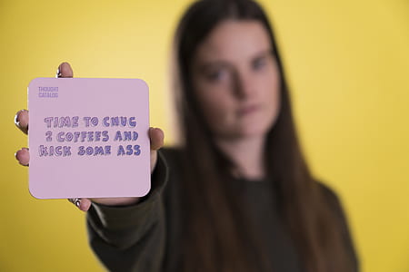 woman holding a card with time to chug 2 coffees and kick some ass sticker thumbnail