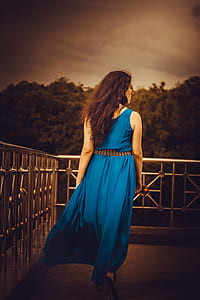 woman wearing blue sleeveless maxi dress thumbnail
