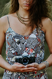 Woman in a dress with a camera thumbnail