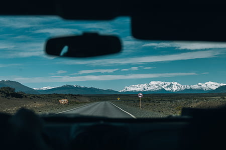 landscape photo of asphalt road between lands in front of mountain alps thumbnail