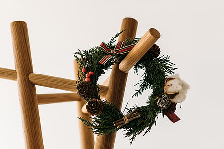 garland wreath on brown wooden rack thumbnail