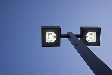 turned-on post lamp under blue sky during daytime thumbnail