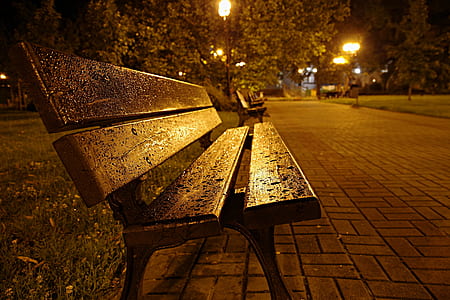 brown wooden bench on pavements thumbnail