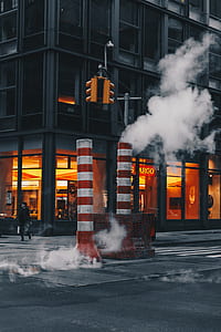 pipe with smoke at street near building thumbnail
