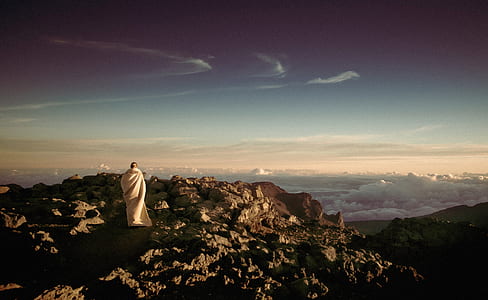 panoramic photography of man on top of mountain thumbnail
