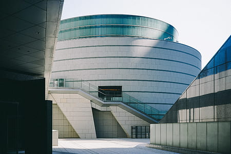 white and gray concrete building under blue sky thumbnail