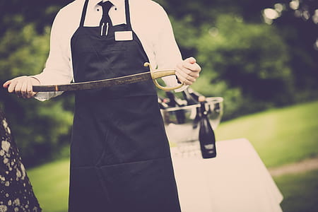 Man Wearing Apron Holding Sword thumbnail