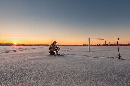 man sitting near white post thumbnail