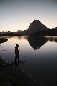 man standing far away from island thumbnail
