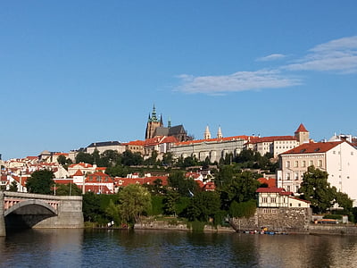 photo of brown and white painted building near body of water at daytime thumbnail