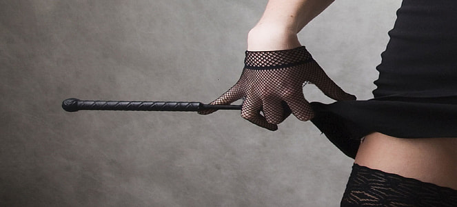 woman with net gloves holding a stick and pulling up her skirt thumbnail