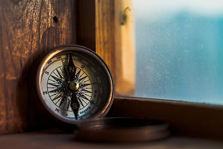 tilt shift lens photography of compass thumbnail
