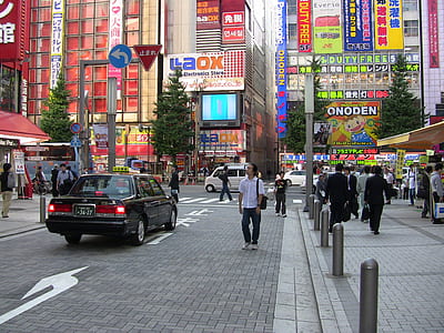 people on busy road beside buildings at daytime thumbnail