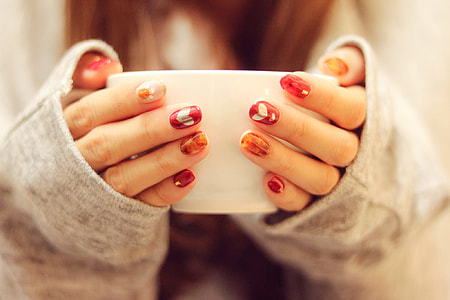 woman holding white cup thumbnail
