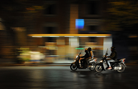 two motor scooter on road in time lapse photo thumbnail