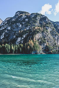 high mountain near body of water thumbnail