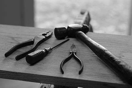 grayscale photo of pliers, screwdriver, and hammer thumbnail