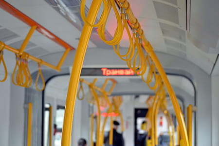 interior photo of train with yellow metal rail handles thumbnail