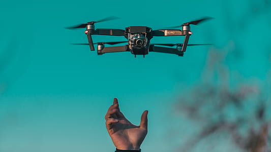 black quadcopter drone floating on air shallow focus photography thumbnail