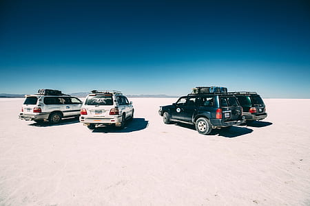 four SUV's on dessert during daytime thumbnail