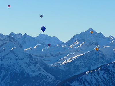 six hot-air balloon  facing tall ice mountains thumbnail