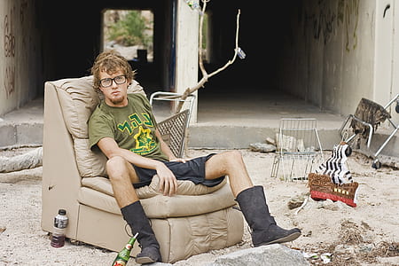 man in green t-shirt sitting on leather chair outdoor during daytime thumbnail