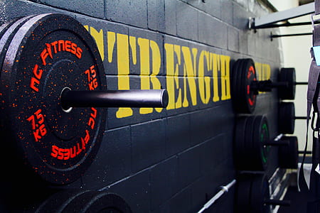 black weight plates hanged on wall thumbnail