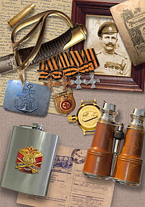 Stainless Steel Flask Beside Brown and Silver Binoculars thumbnail