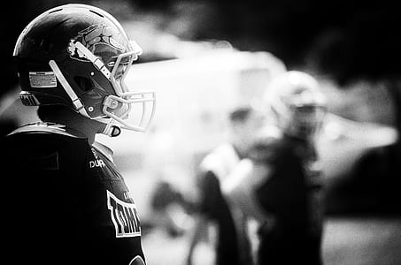 selective focus photography of football player thumbnail