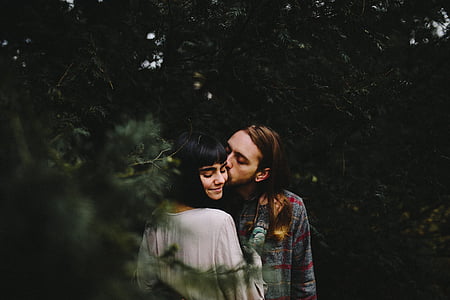man kissing woman at left cheek thumbnail