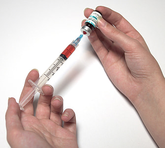 person holding syringe and bottle thumbnail