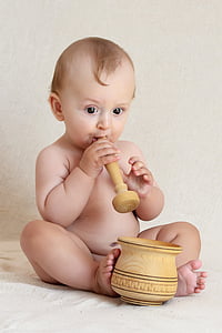 baby boy holding mortar and pestle thumbnail