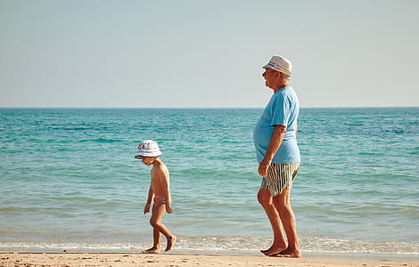 man and boy walking at the shore thumbnail