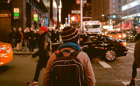 people walking on sidewalk with cars passing on road thumbnail