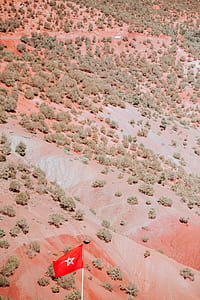 aerial view of open field with red and white star flag thumbnail