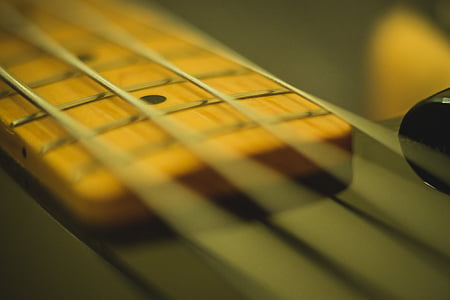 selective focus photography of guitar strings thumbnail
