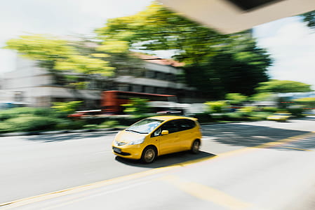 panning photography of yellow 5-door hatchback thumbnail