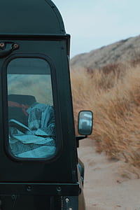 black SUV beside grass field thumbnail