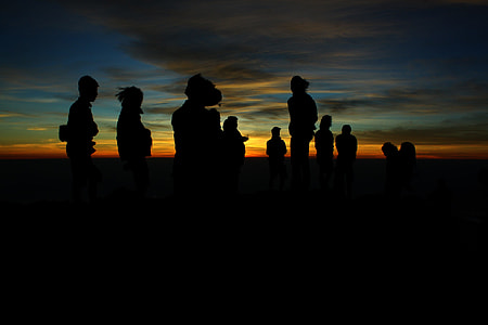 group of people standing during golden hour thumbnail