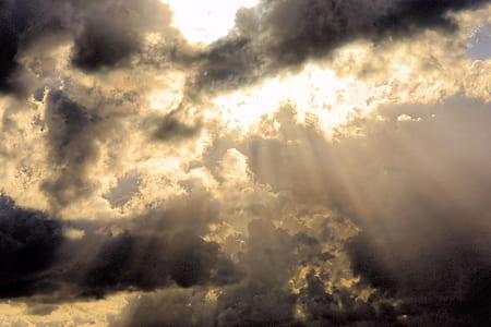 perforated sun rays under cumulonimbus clouds thumbnail