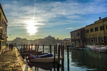 people walking near body of water with boats during daytime thumbnail