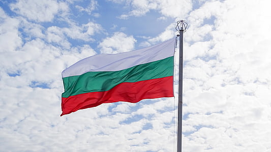 white, green, and red flag under white clouds at daytime thumbnail