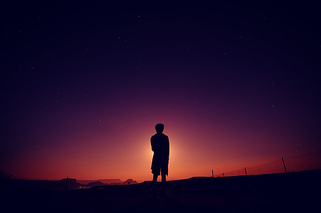 silhouette of man standing during golden hour thumbnail