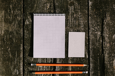White smartphone with various items on a wooden background thumbnail