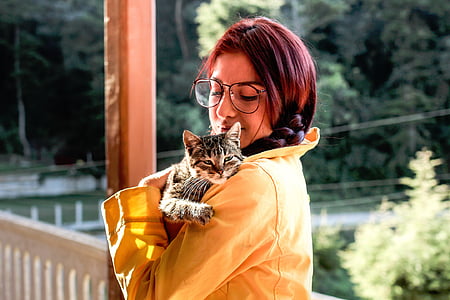 woman holding black cat near balustrade thumbnail