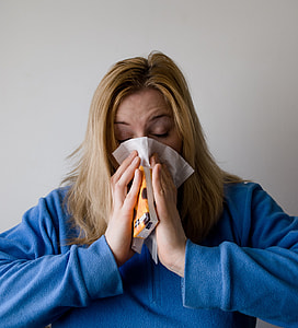 woman pressing her nose with facial tissue thumbnail