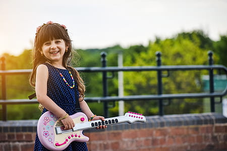 girl playing a white guitar thumbnail